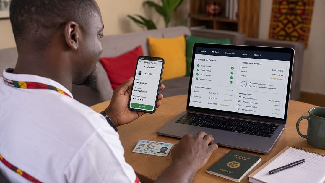 Man checking a Mobile Money deposit, account verification and betting withdrawal in Ghana